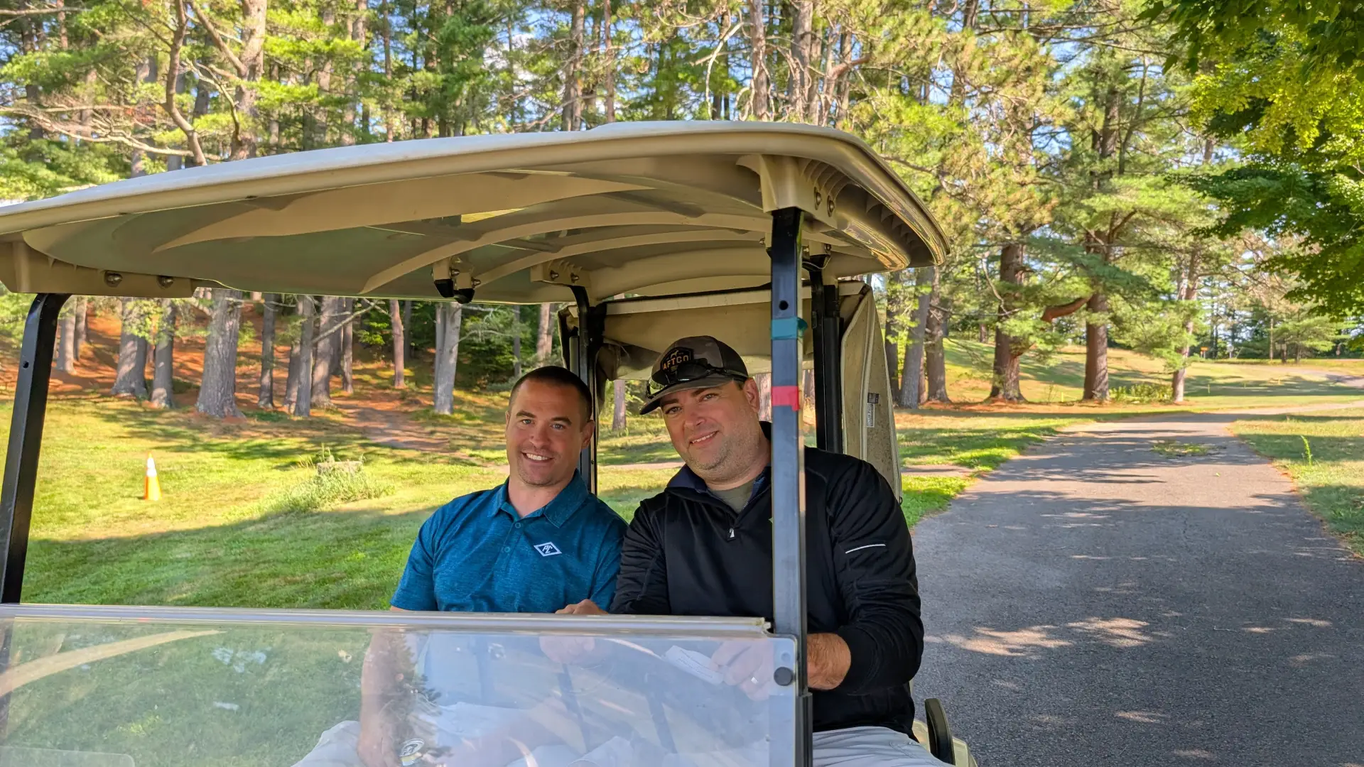 golfers riding a cart