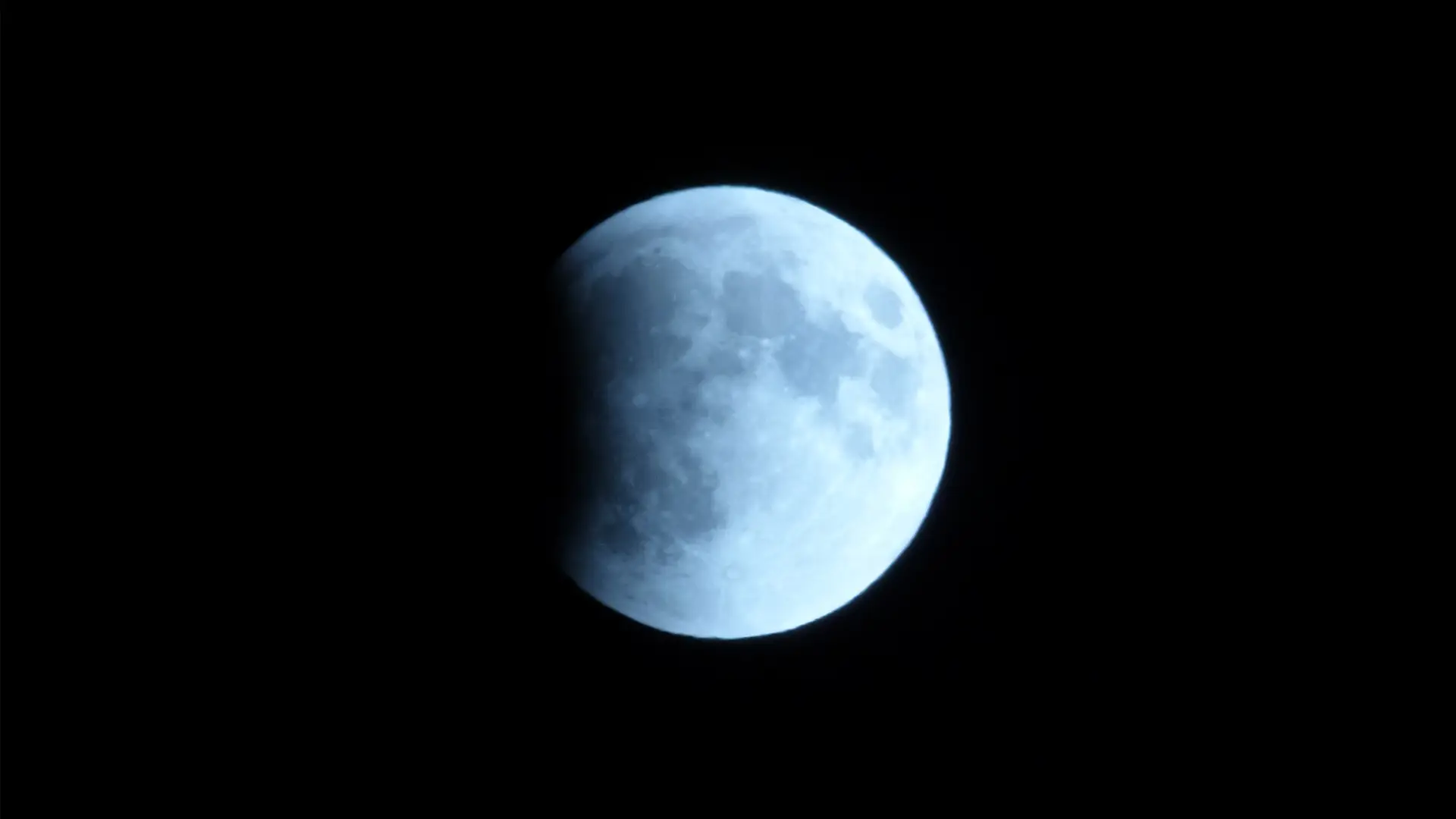 The moon up close, reflecting the sun's light with a black sky behind it