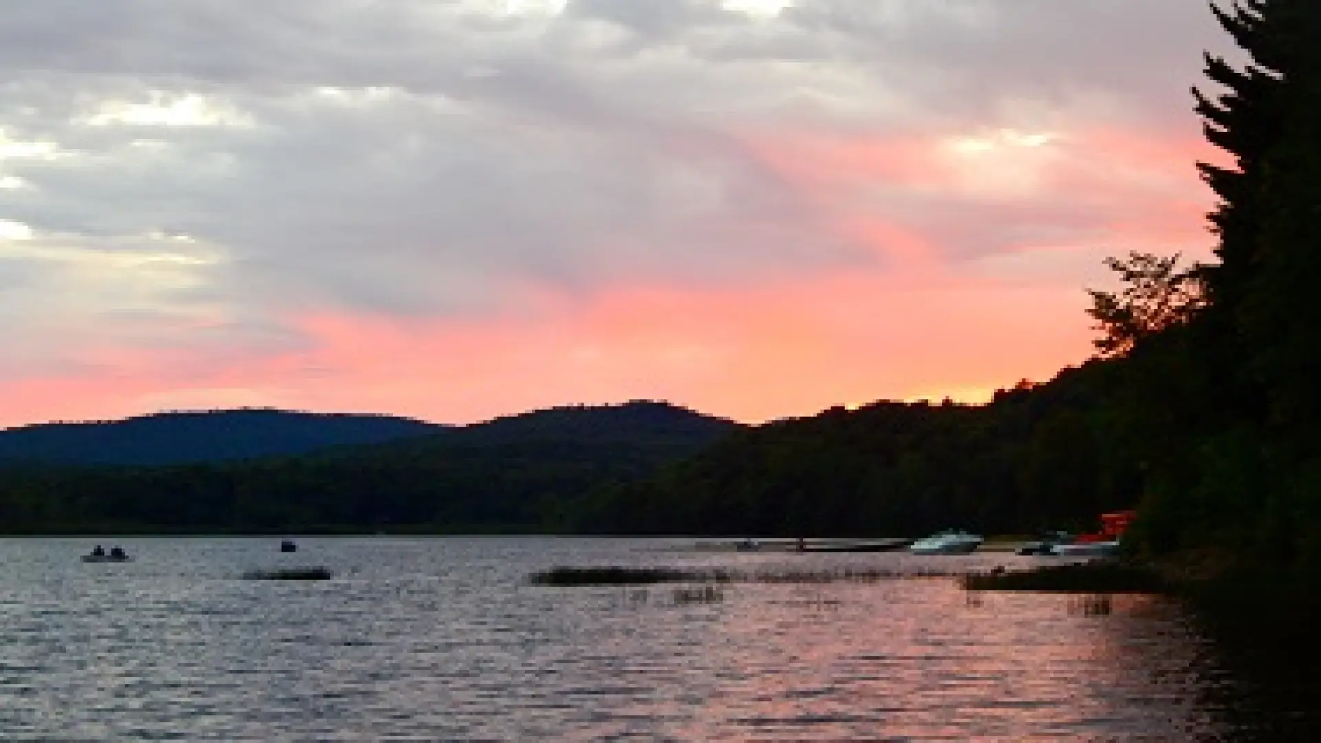 A sunset from a campground by the water