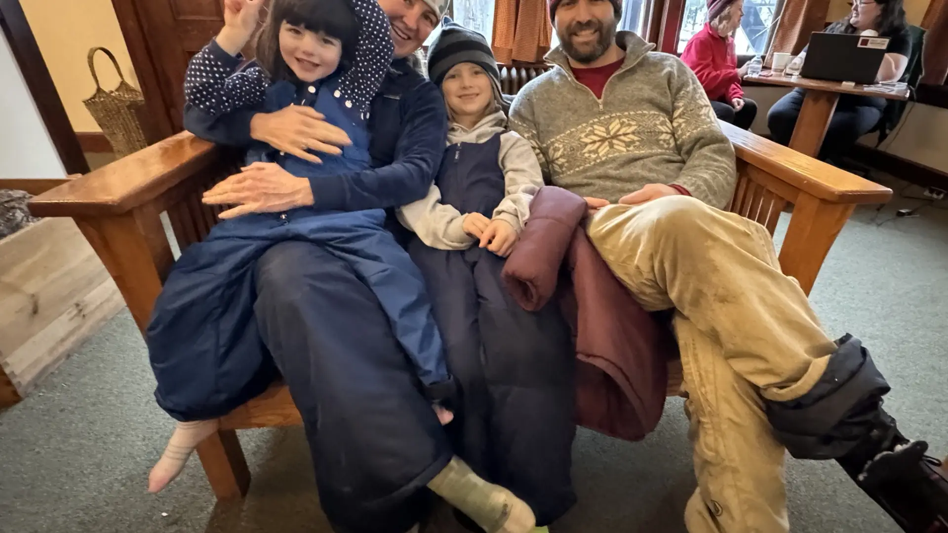 A family enjoying the warmth of being inside the building