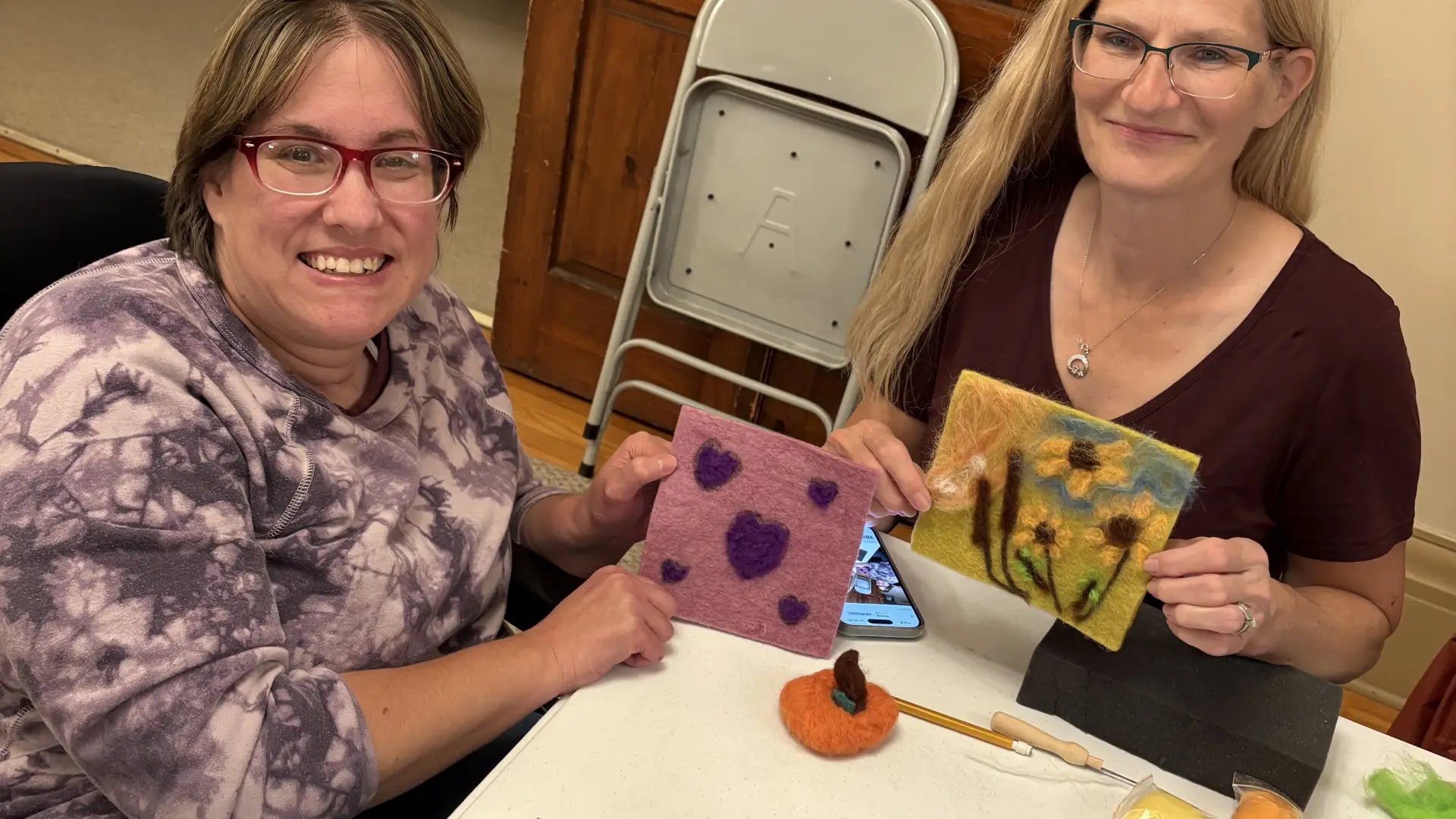 ladies showing us their felting project of hearts & flowers