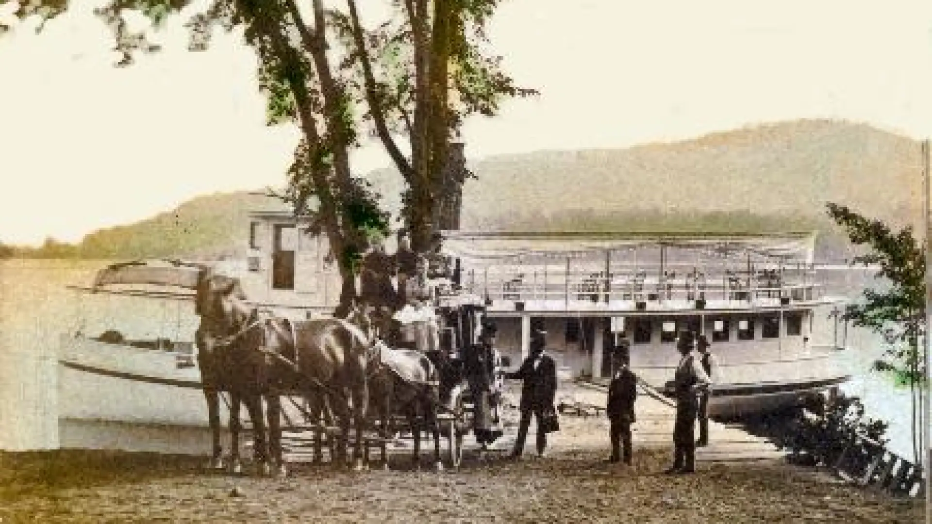 Horse and carriage with some smartly dressed men stand in front of a large boat in this historical photo.