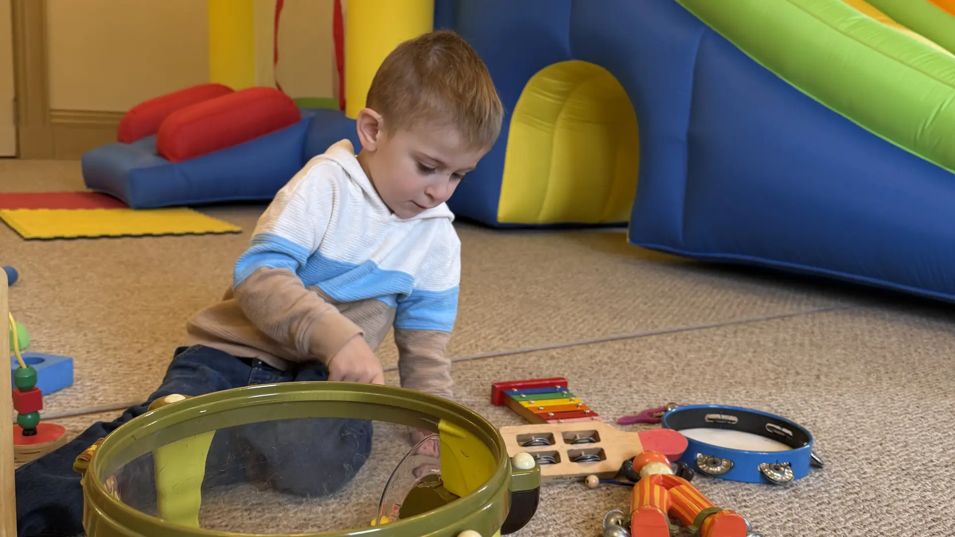 boy playing with toys at the tots bounce house