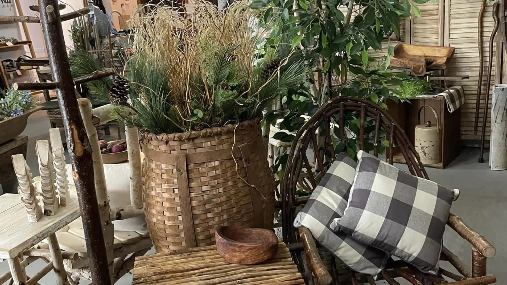 Woven twig chairs, tables and pack baskets stuffed with greenery