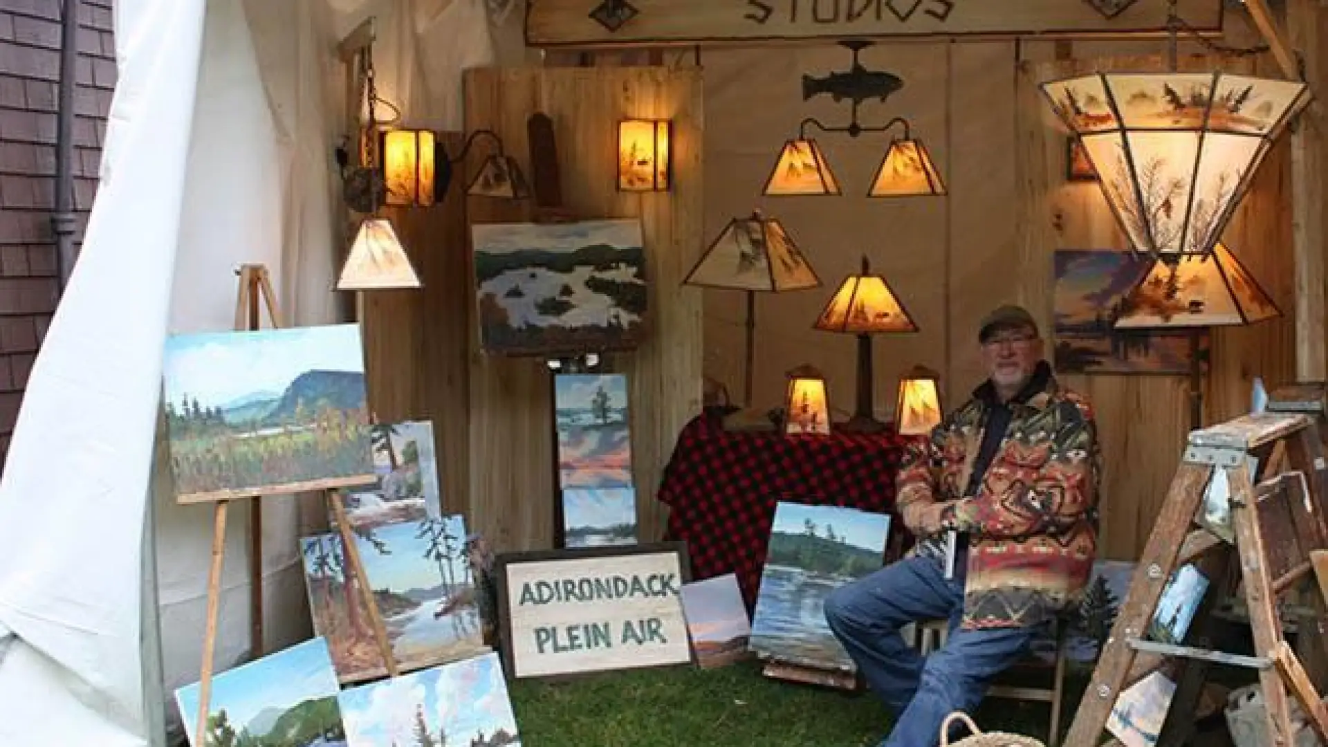 A booth selling art and lamps