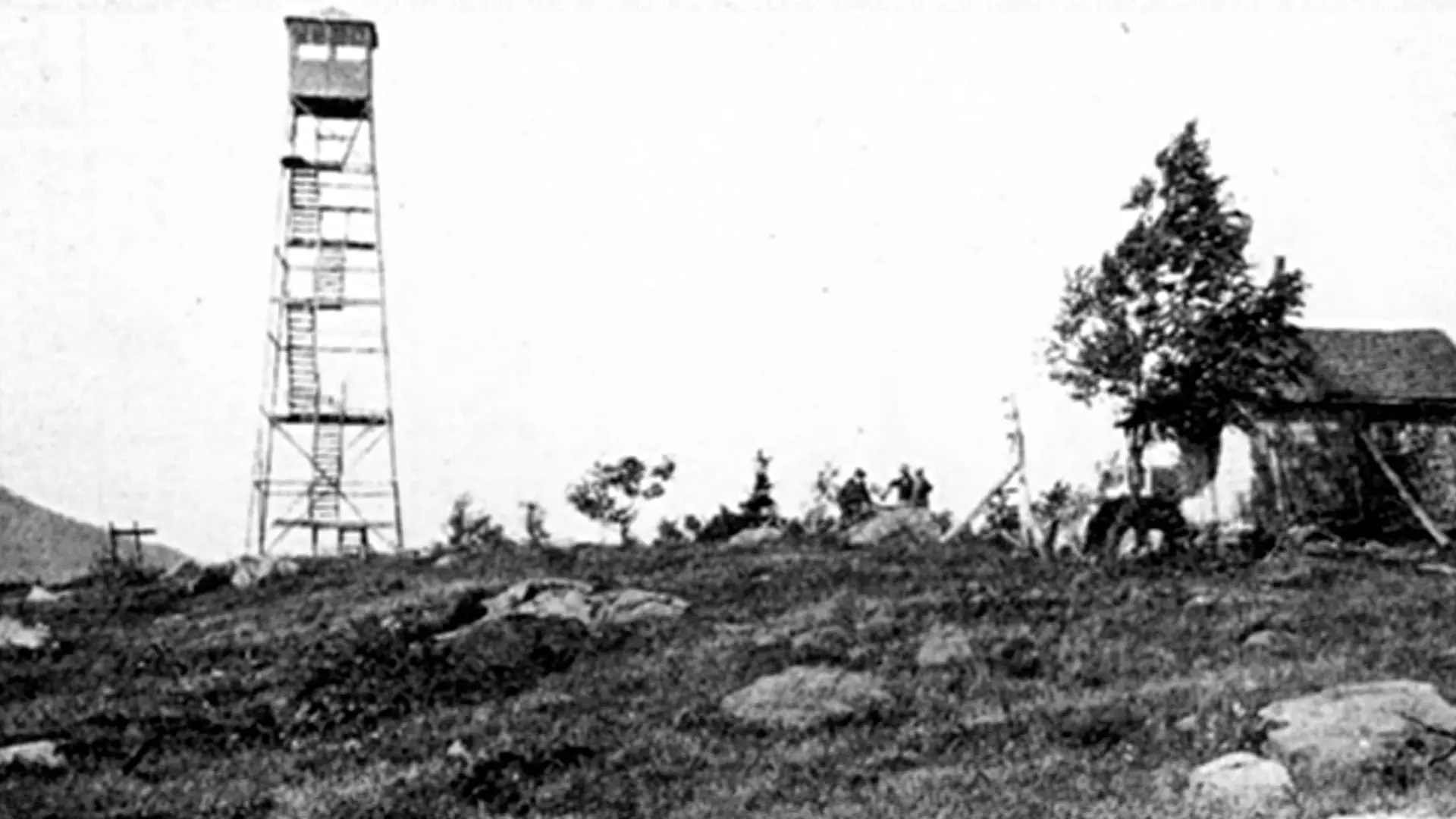 A historic photo of the Makomis fire tower sitting atop Makomis Mountain