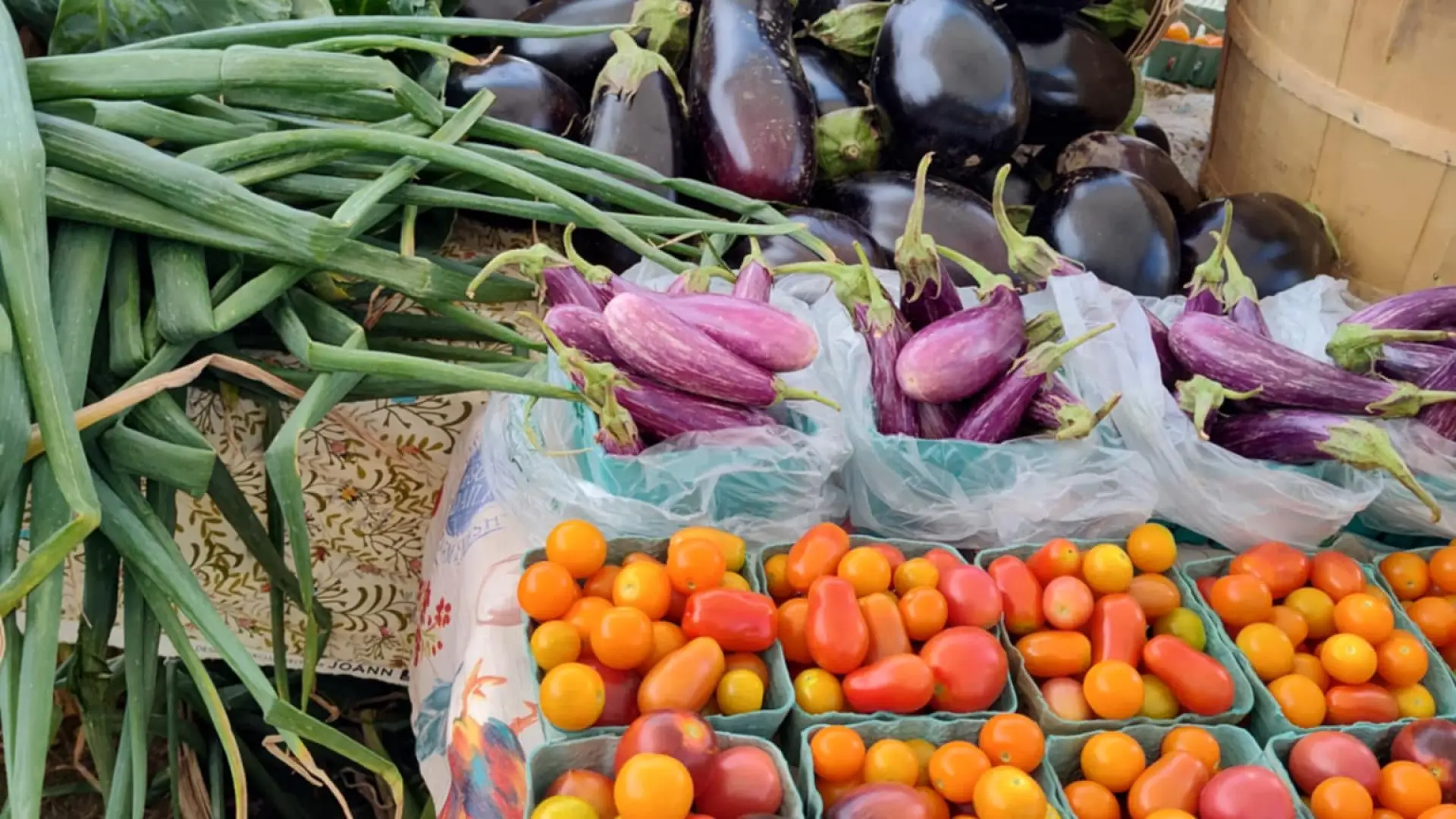 Photo of a variety of vegetables for sale at a farmers market.
