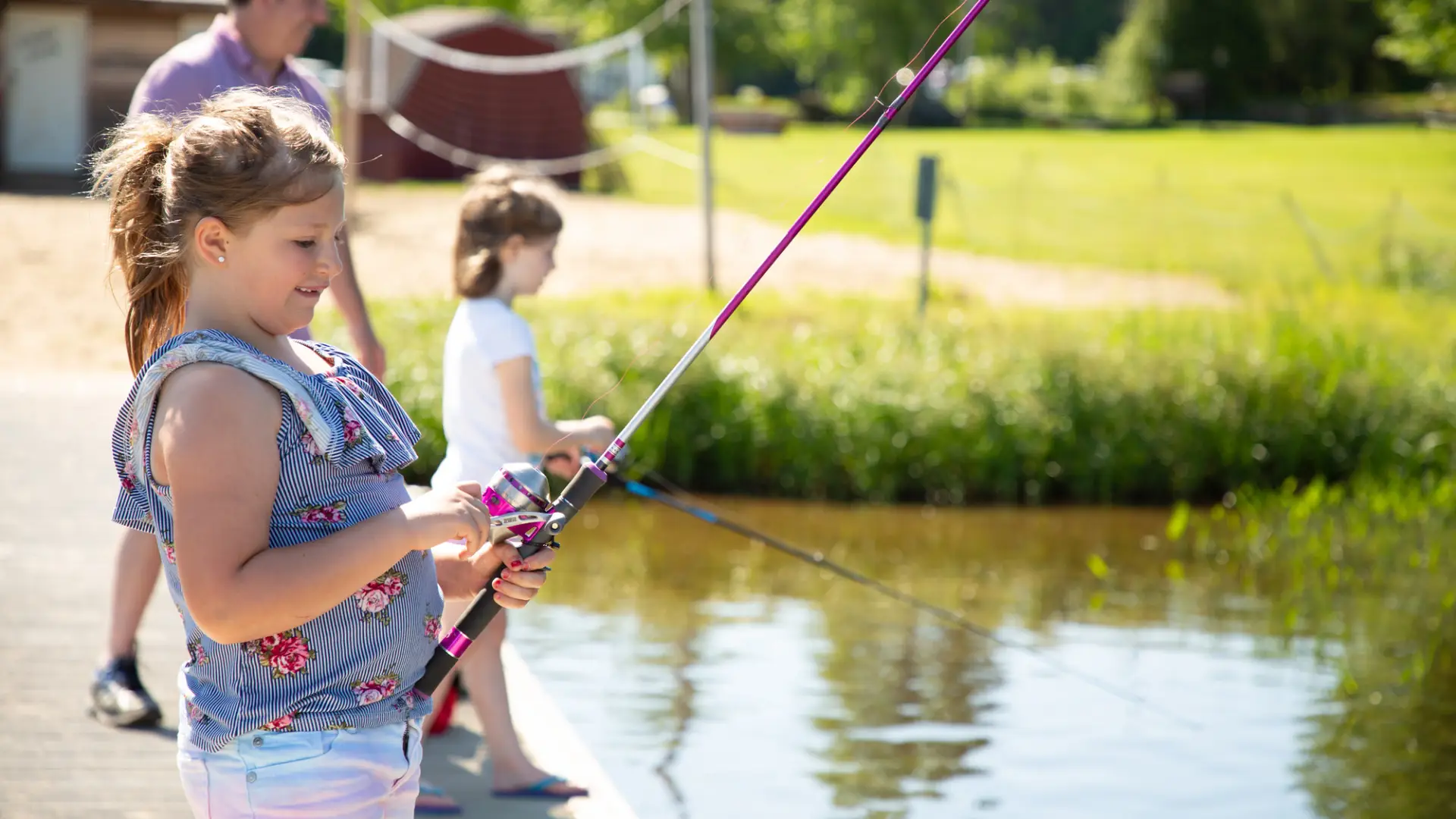 Two girls fishing from a dock