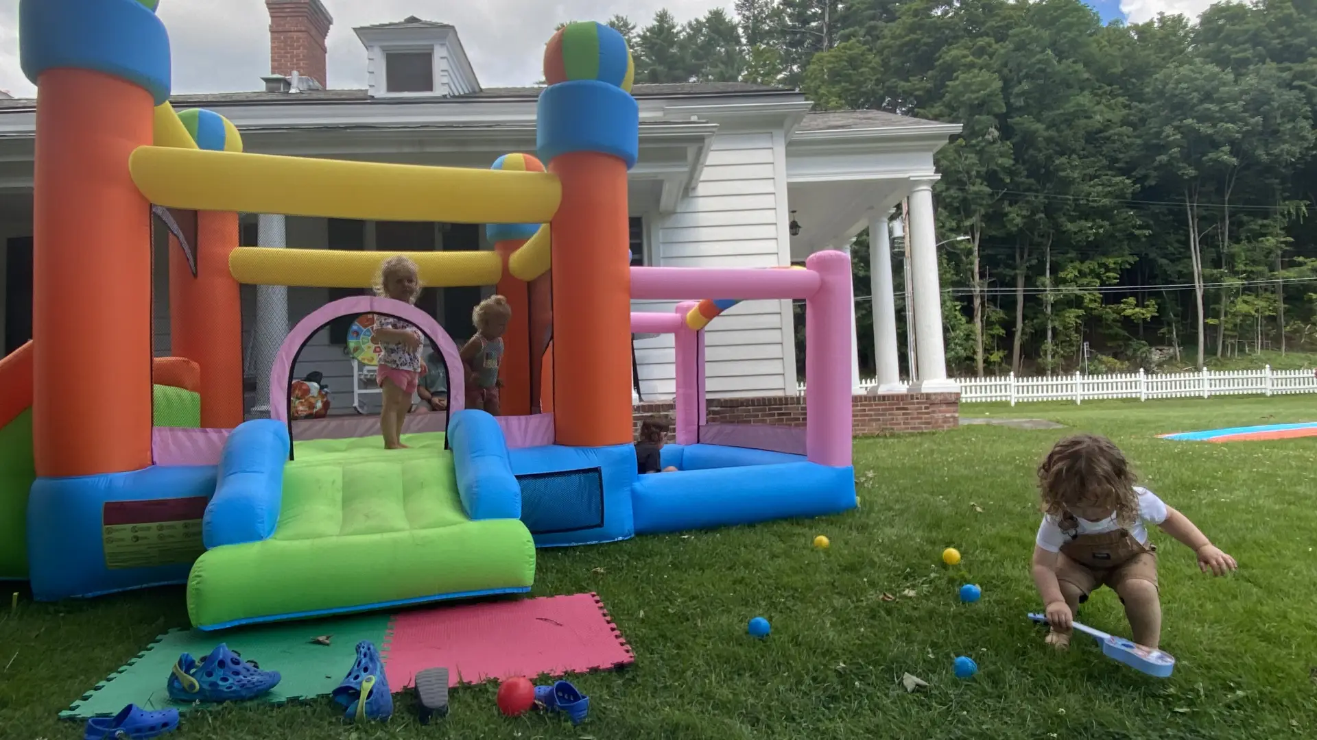 outdoors bounce house with tots having fun