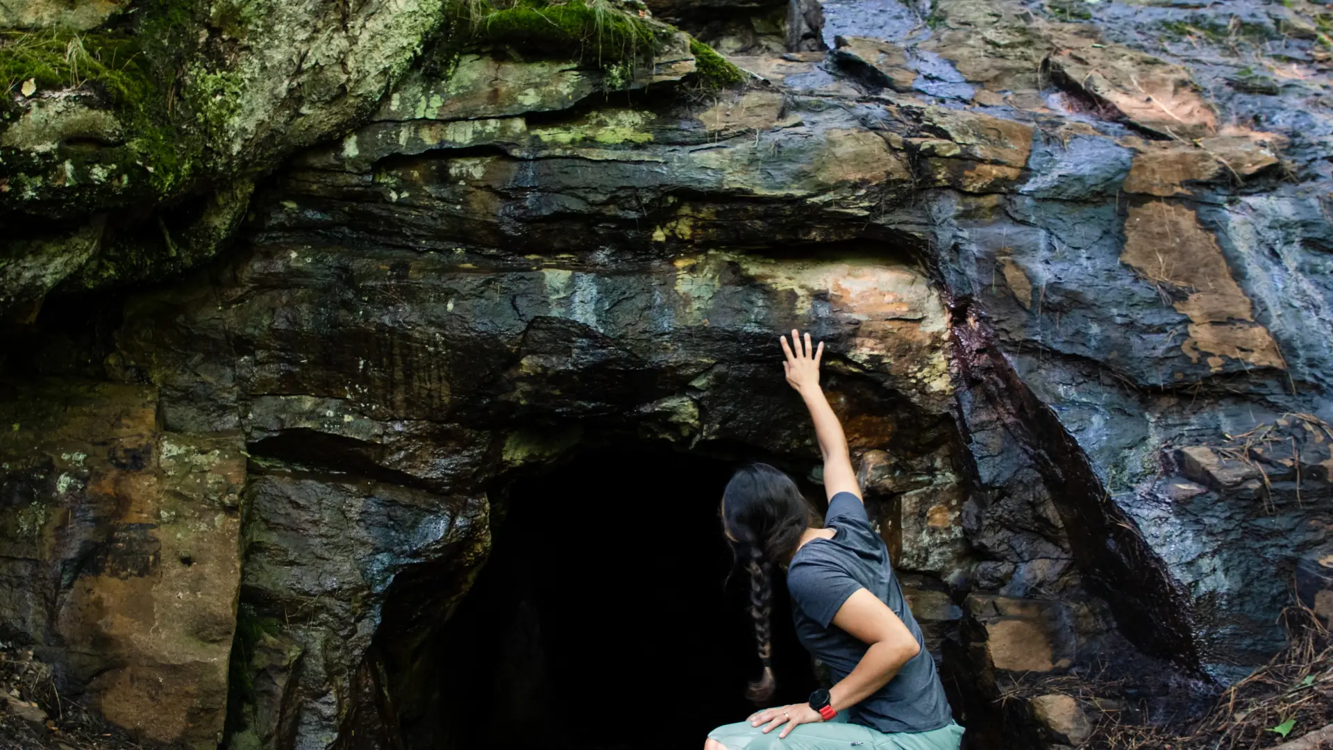 A woman looks into Kunjamuk Cave.
