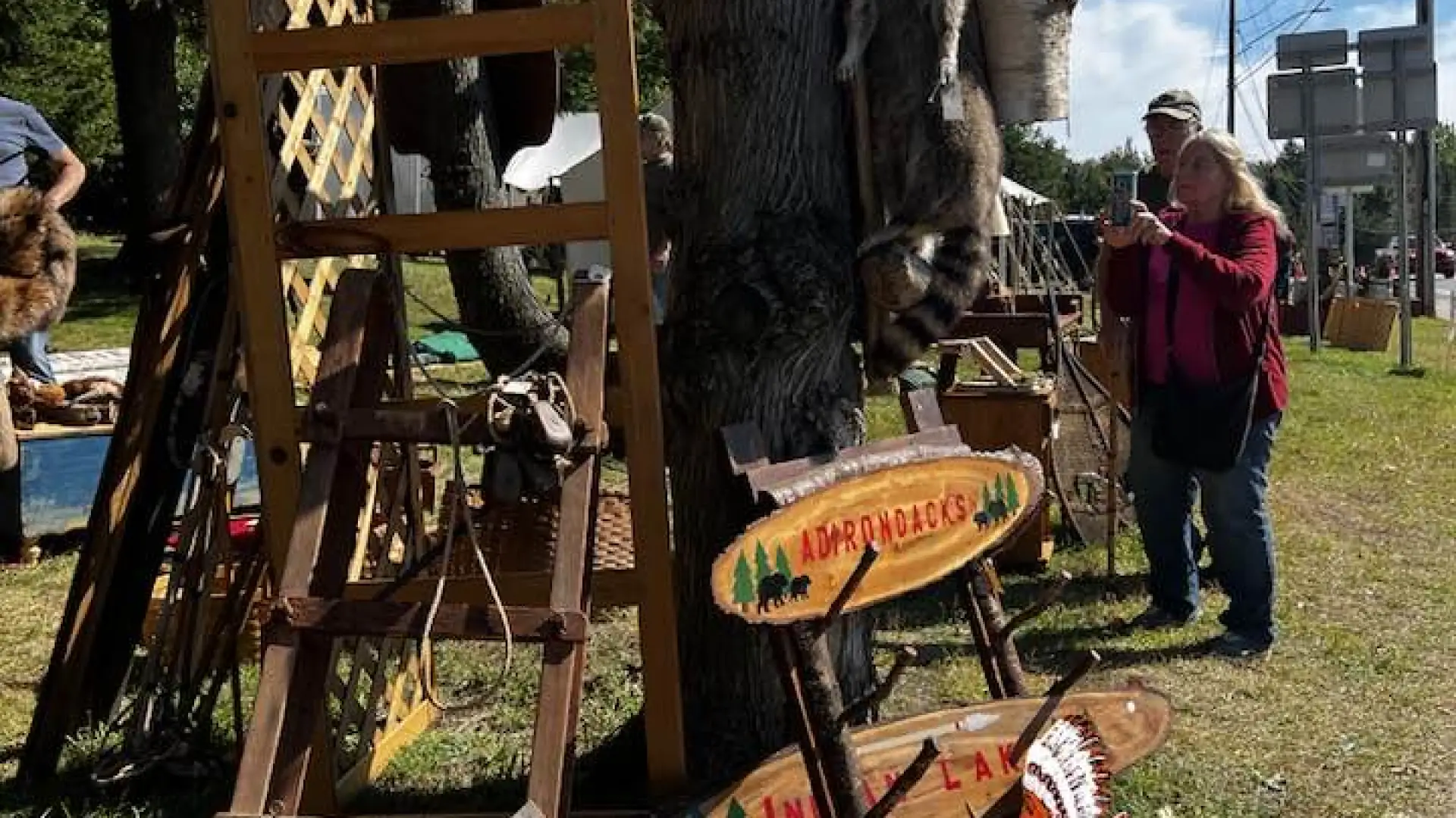 A variety of antiques on display with people browsing the items