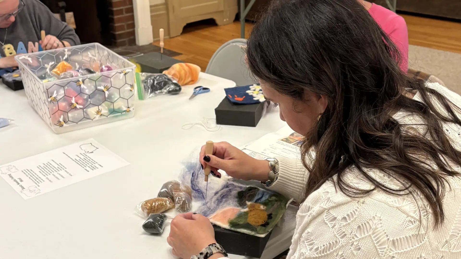 lady felting a scene with a cow