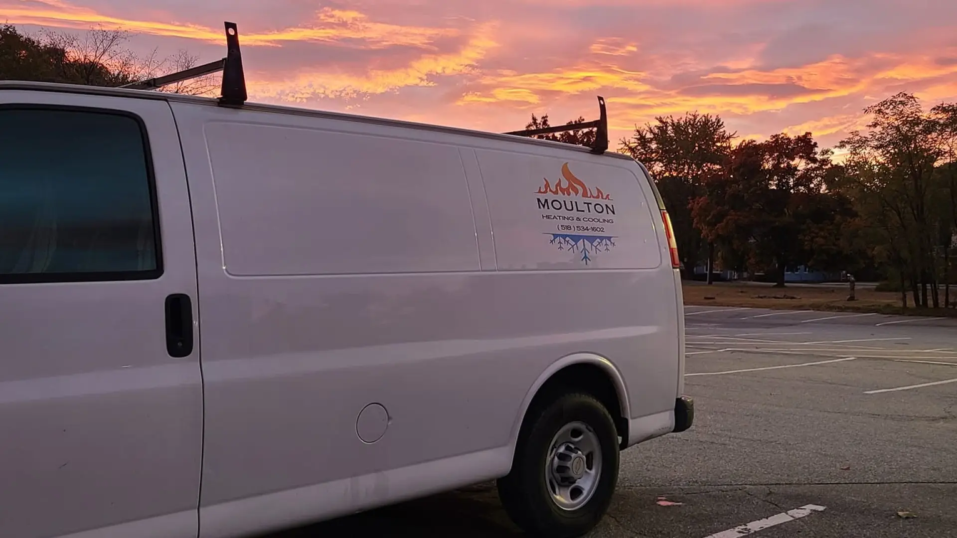 White utility van with Moulton logo at sunrise