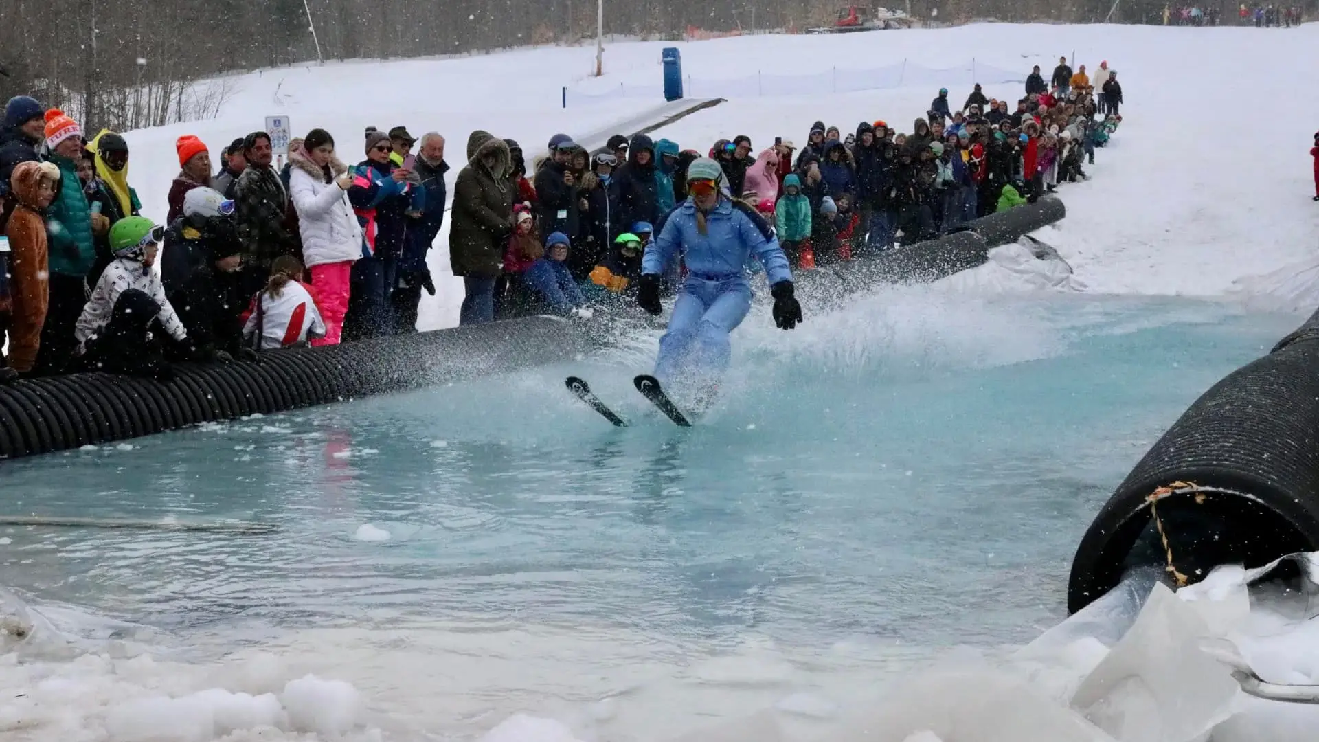 a skiier skimming across the pool of water
