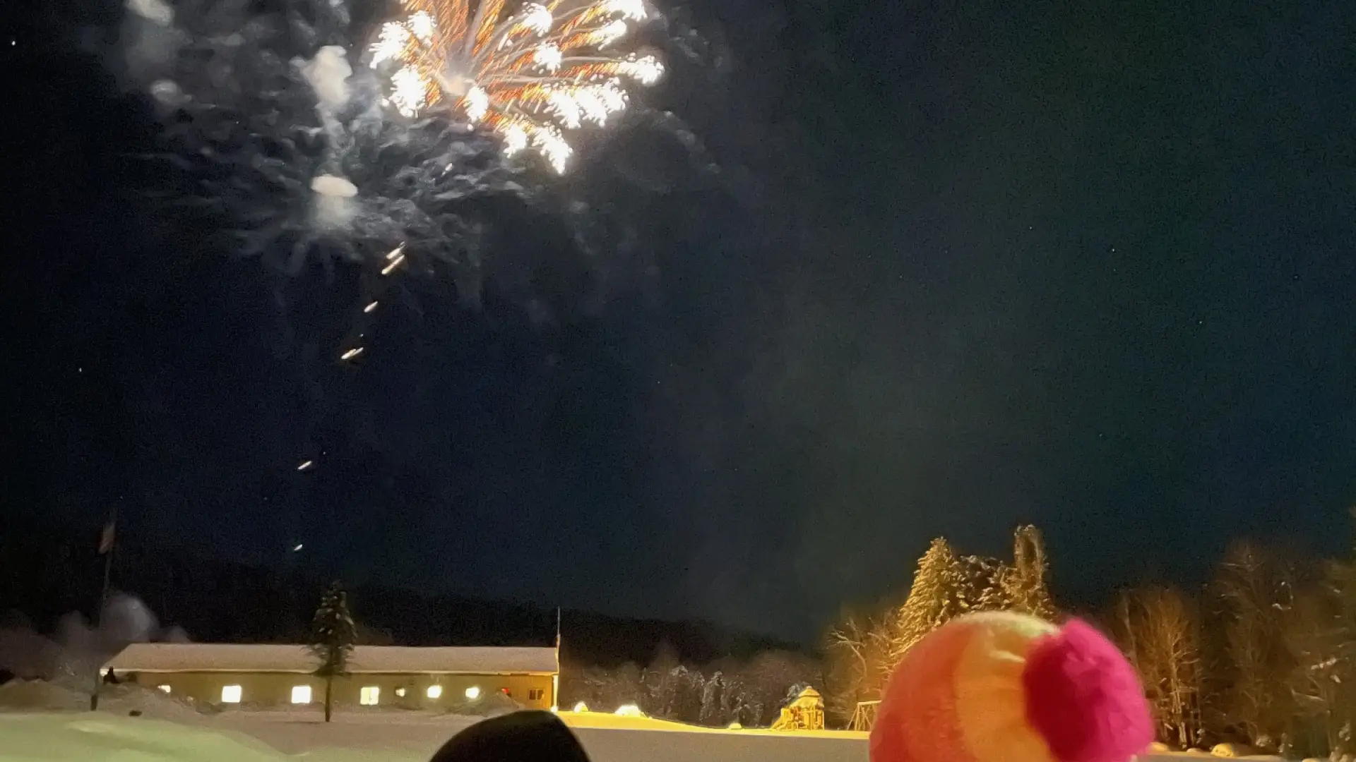 two kids watching the fireworks over the Morehouse rec center