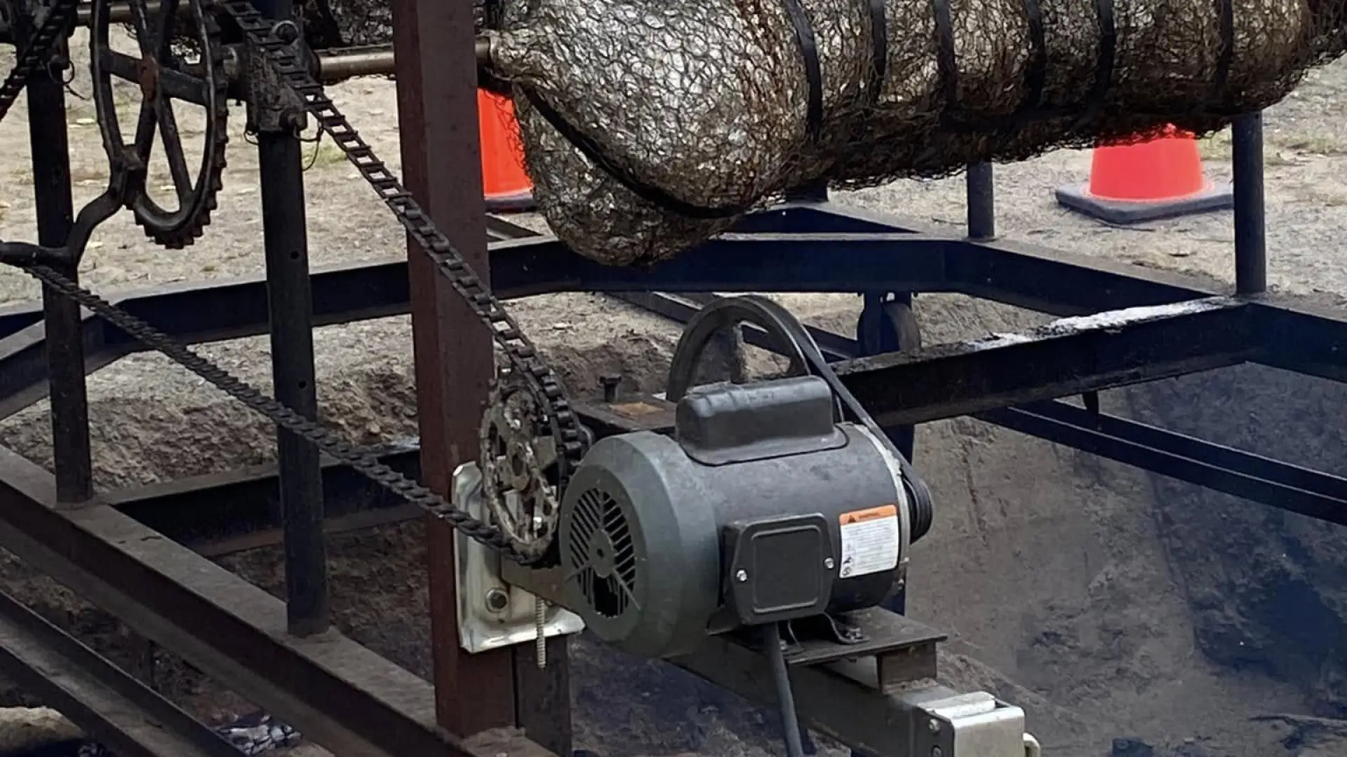 Two pigs on a spit roasting