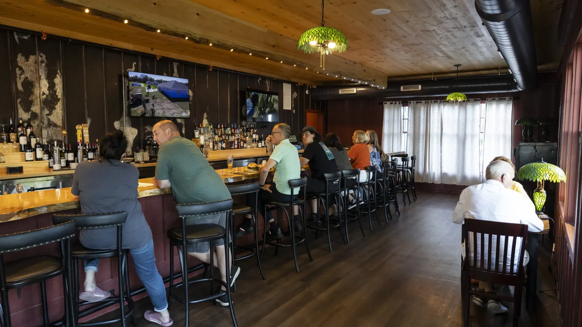 The classic bar area with dark woods and dimmed lighting