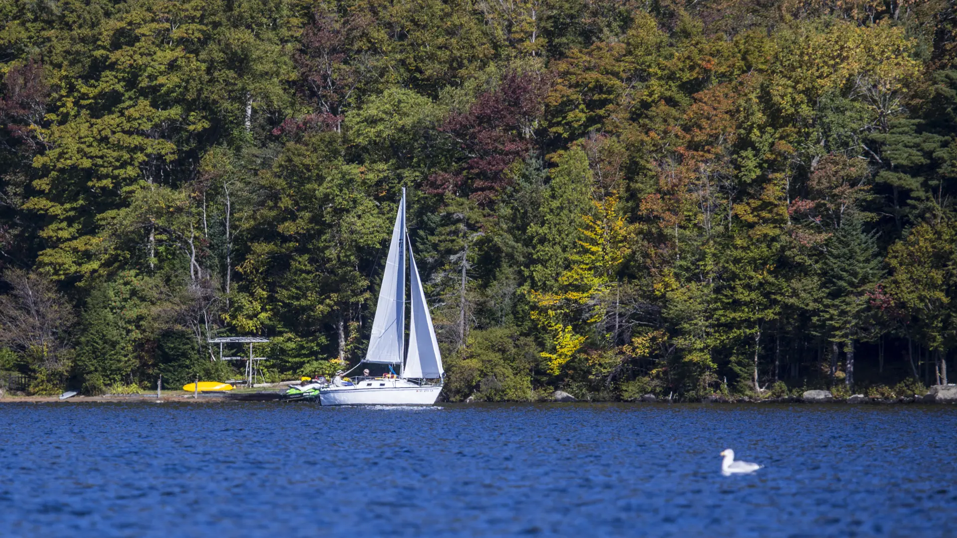 A sailboat coasts across Eighth Lake