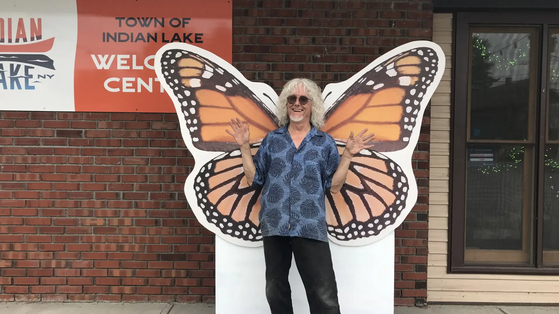 a man posing in front of the monarch photo prop