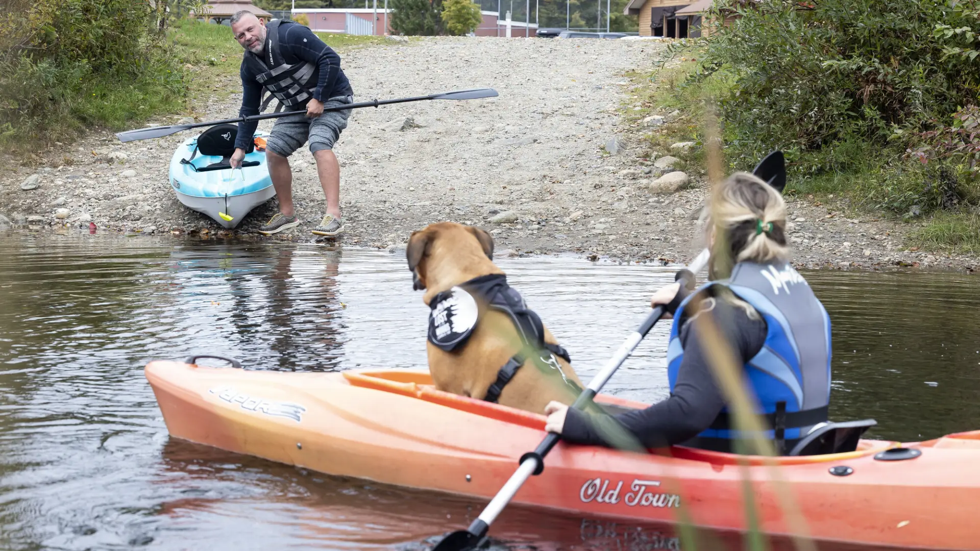 A couple kayakers by a hand launch