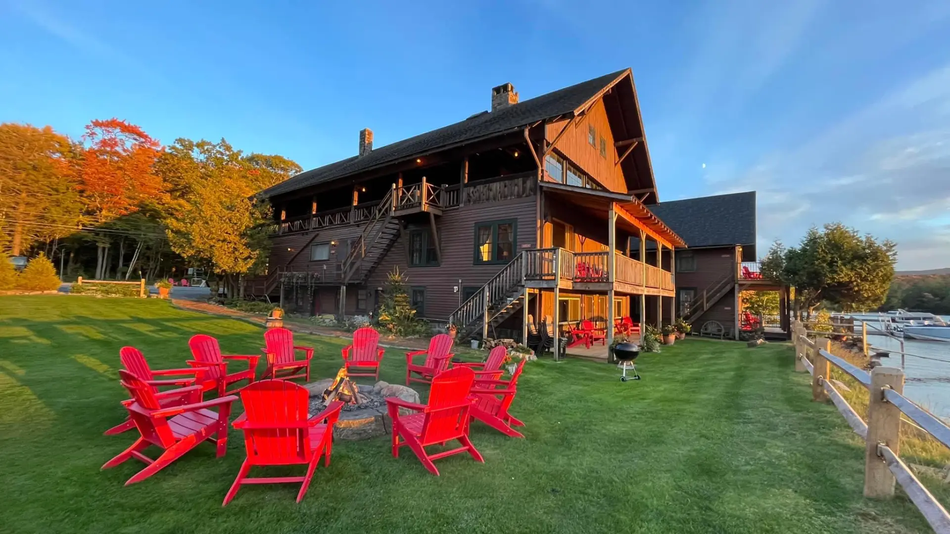 Lush lawn and red adirondack chairs out front of the Steamboat Landing