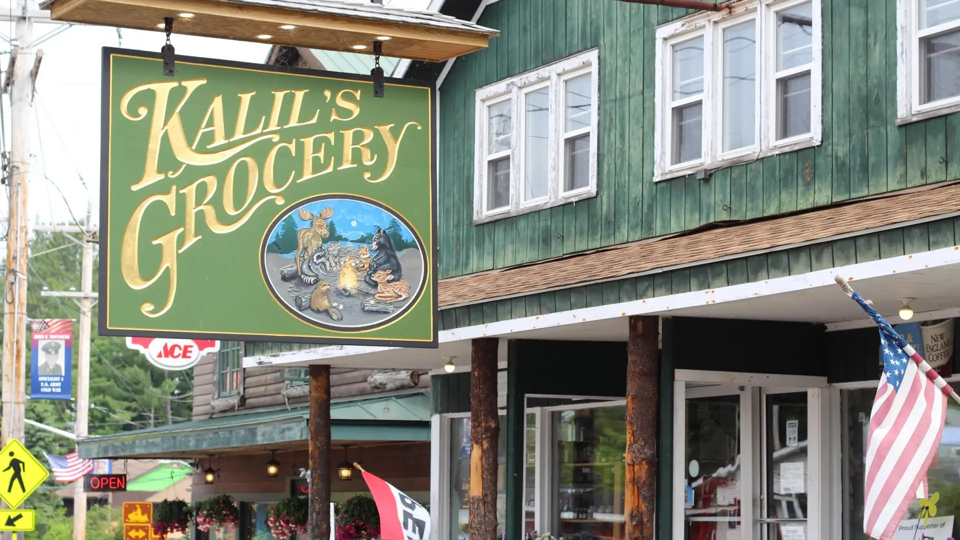 A green sign with gold lettering reading 'Kalil's Grocery"