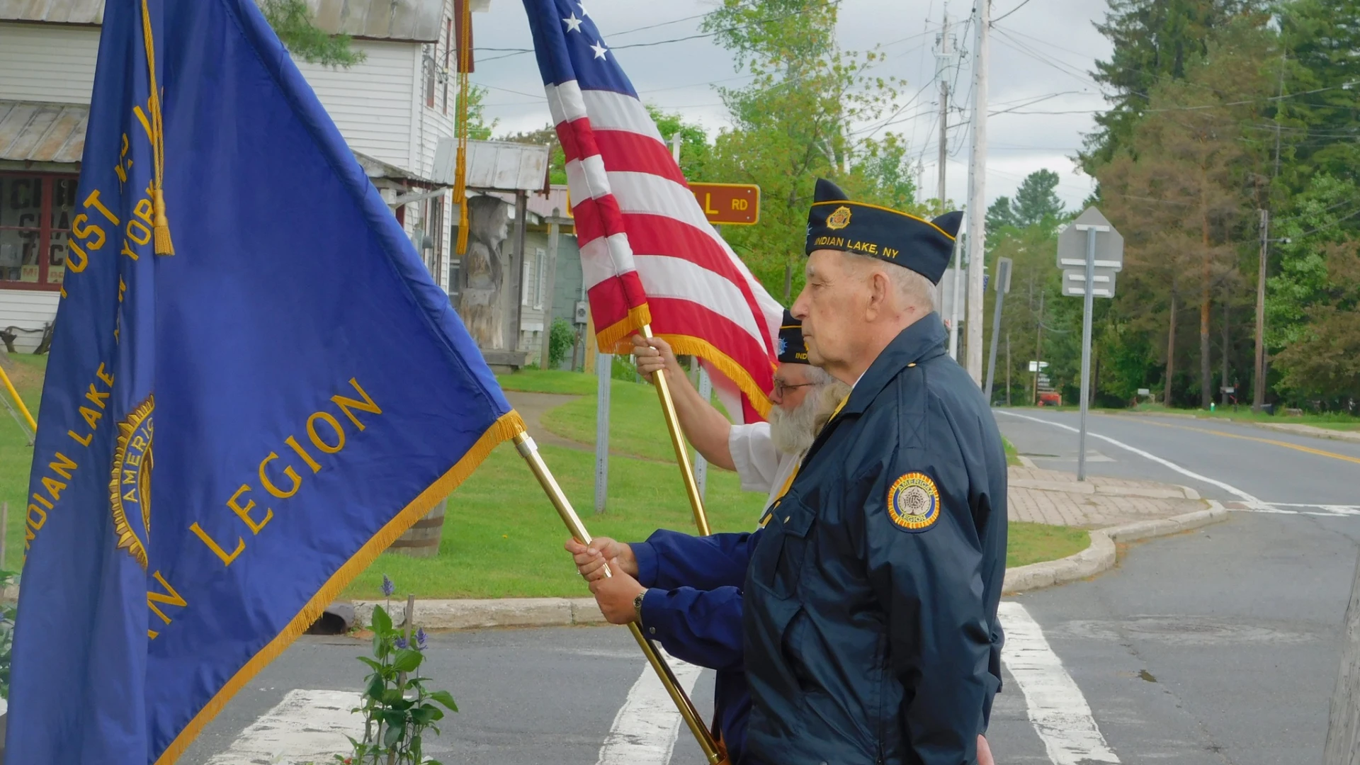 Men from the American Legion carrying flags