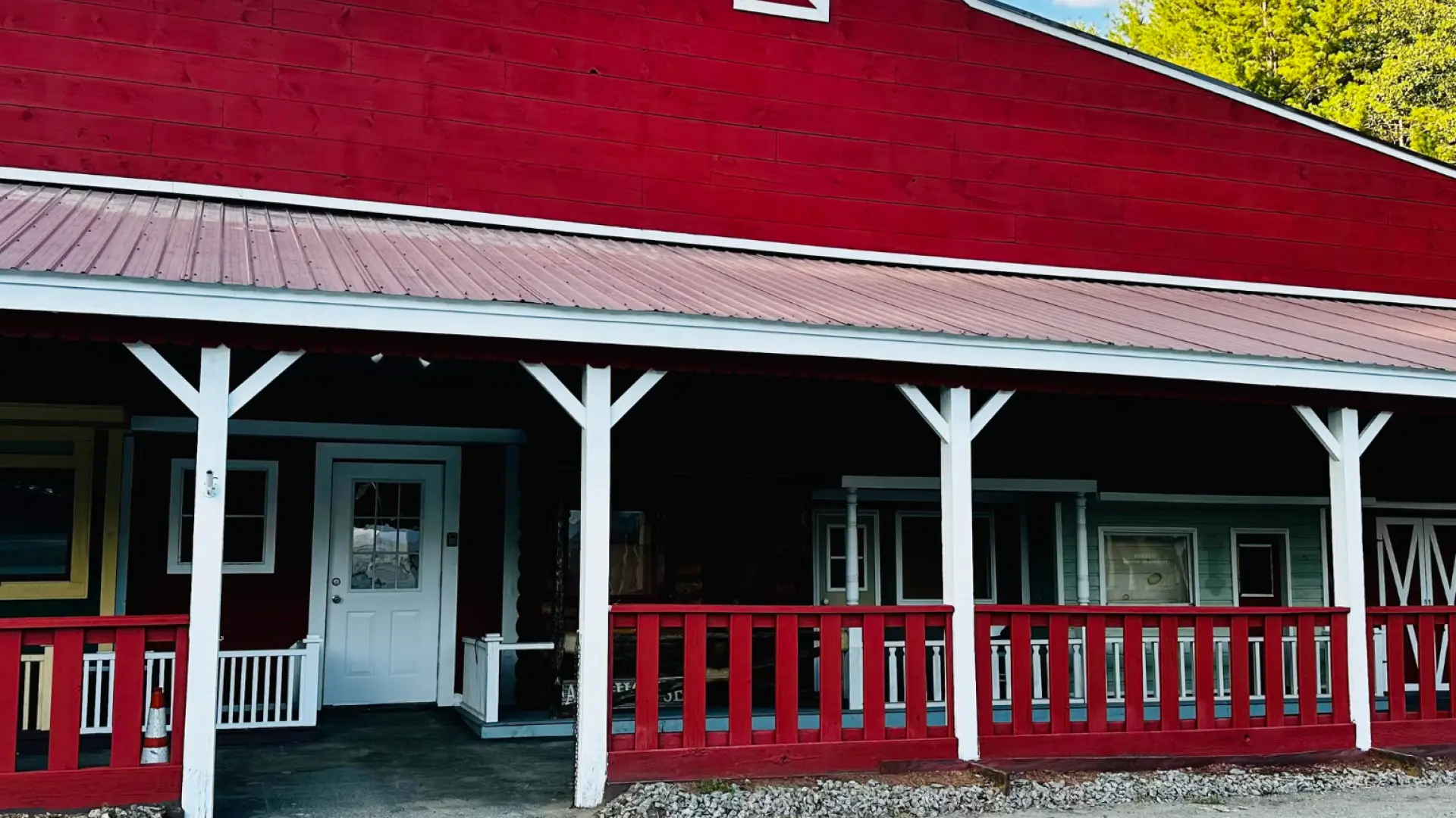 An image of the exterior of the Hay Fields antiques barn which is red with white trim.