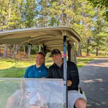 golfers riding a cart