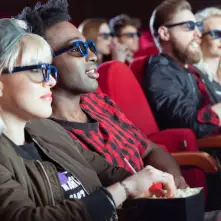 People sitting in a movie theater watching a movie.