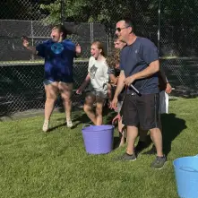teens having water relay races