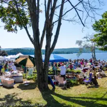 Vendors booths line the green by the lake