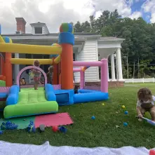 outdoors bounce house with tots having fun