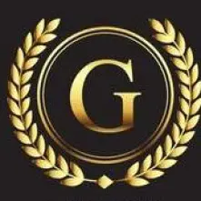 A gold G in the center of a circle ringed with olive leaves.