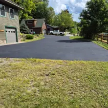 freshly sealed driveway in front of garage