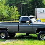 Truck outside in front of the Old Mill Sign
