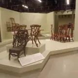 A new exhibit displaying many intricate, handmade chairs from centuries past