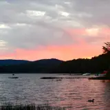 A sunset from a campground by the water