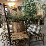 Woven twig chairs, tables and pack baskets stuffed with greenery