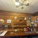 Entry sign for the Adirondack Buffalo Company with various merchandise for sale surrounding it