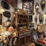 A huge range of rustic decor from bark picture frames to show shoe lamps surrounding a birch bark hutch.