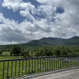 A view of the mountains and puffy clouds that surround the buffalo pastures