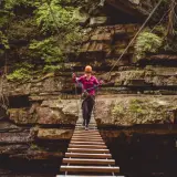 Take a daring walk across a wooden bridge to give unique perspective on the chasm