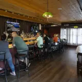 The classic bar area with dark woods and dimmed lighting