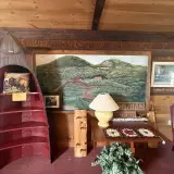 A large painting of the buffalo pasture with the buildings looking down over them.