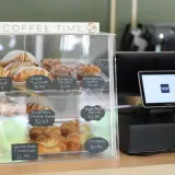 A glass case holding a variety of specialty baked goods.