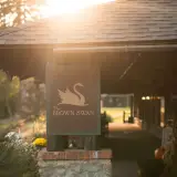 Sign for the Brown Swan on a stone pillar at golden hour.