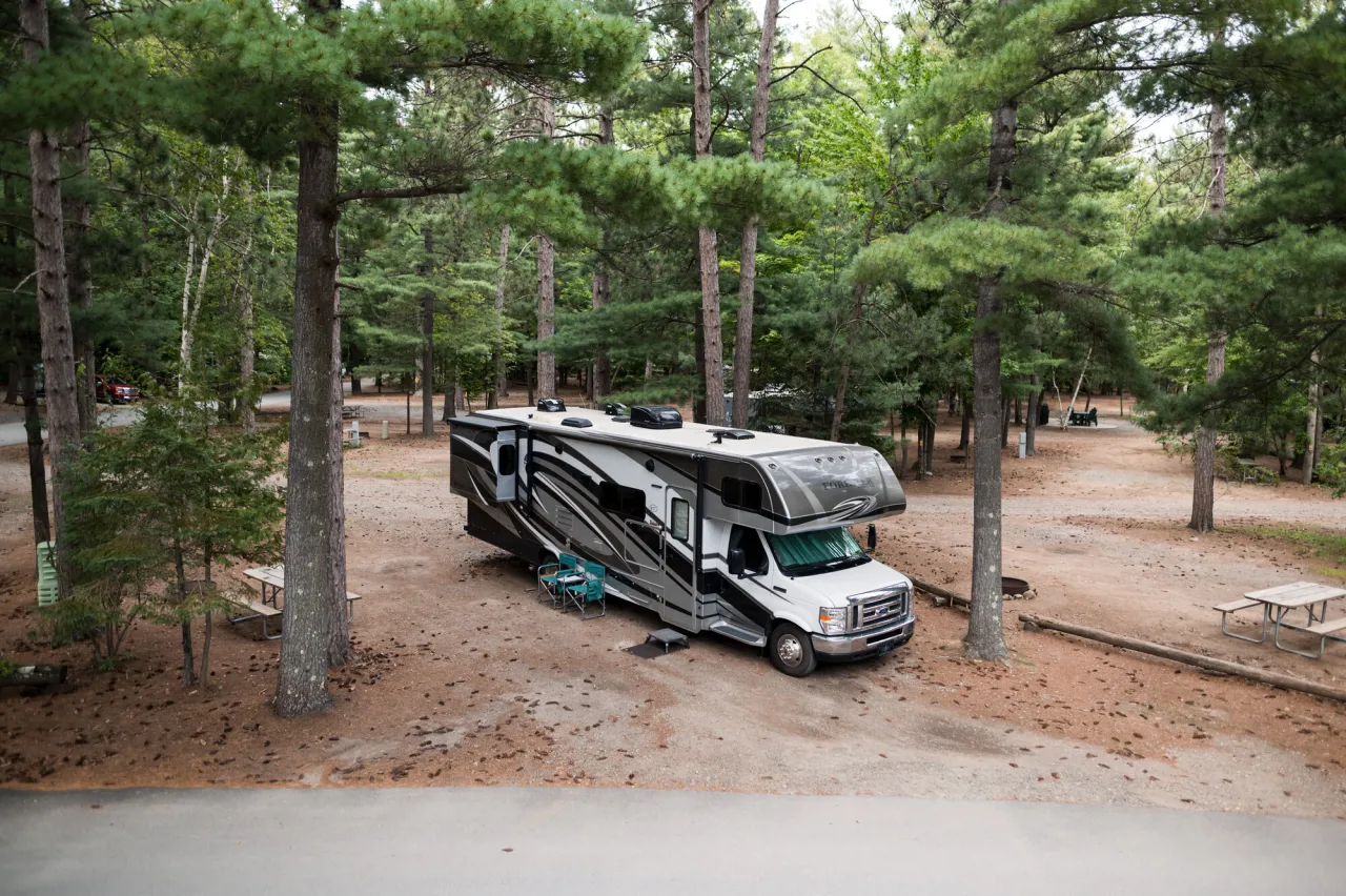 An RV parks at a campsite.