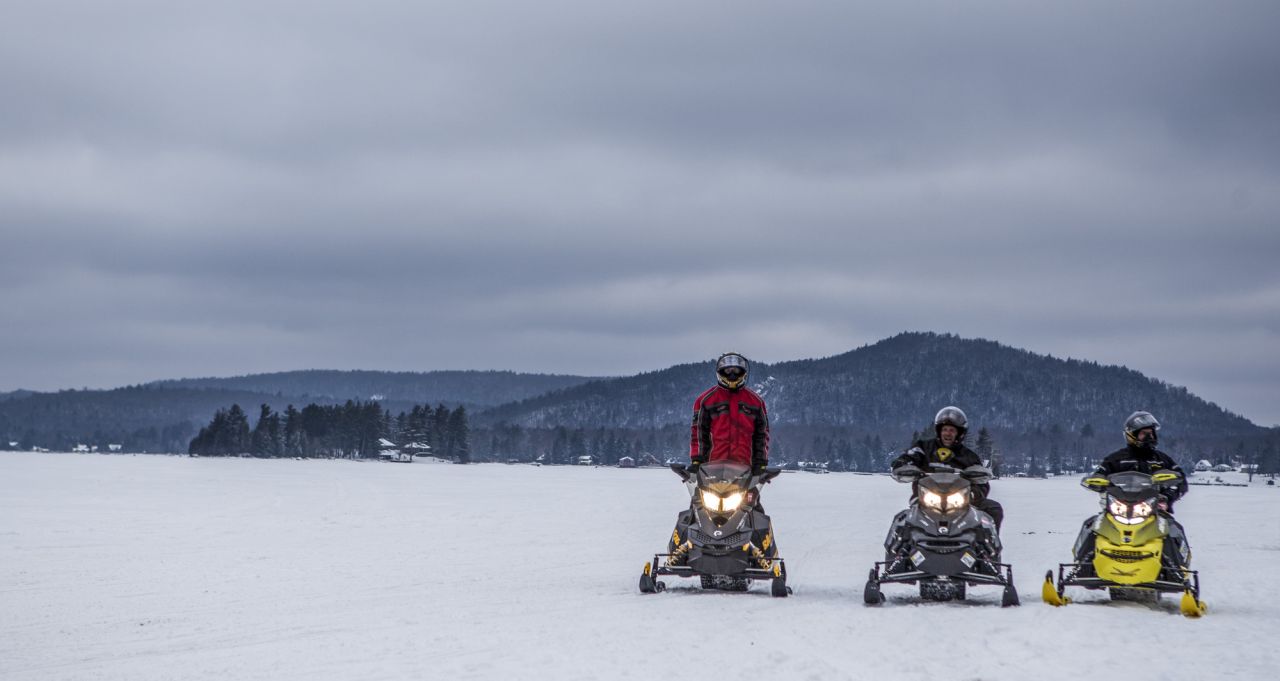 snowmobiles on frozen lake