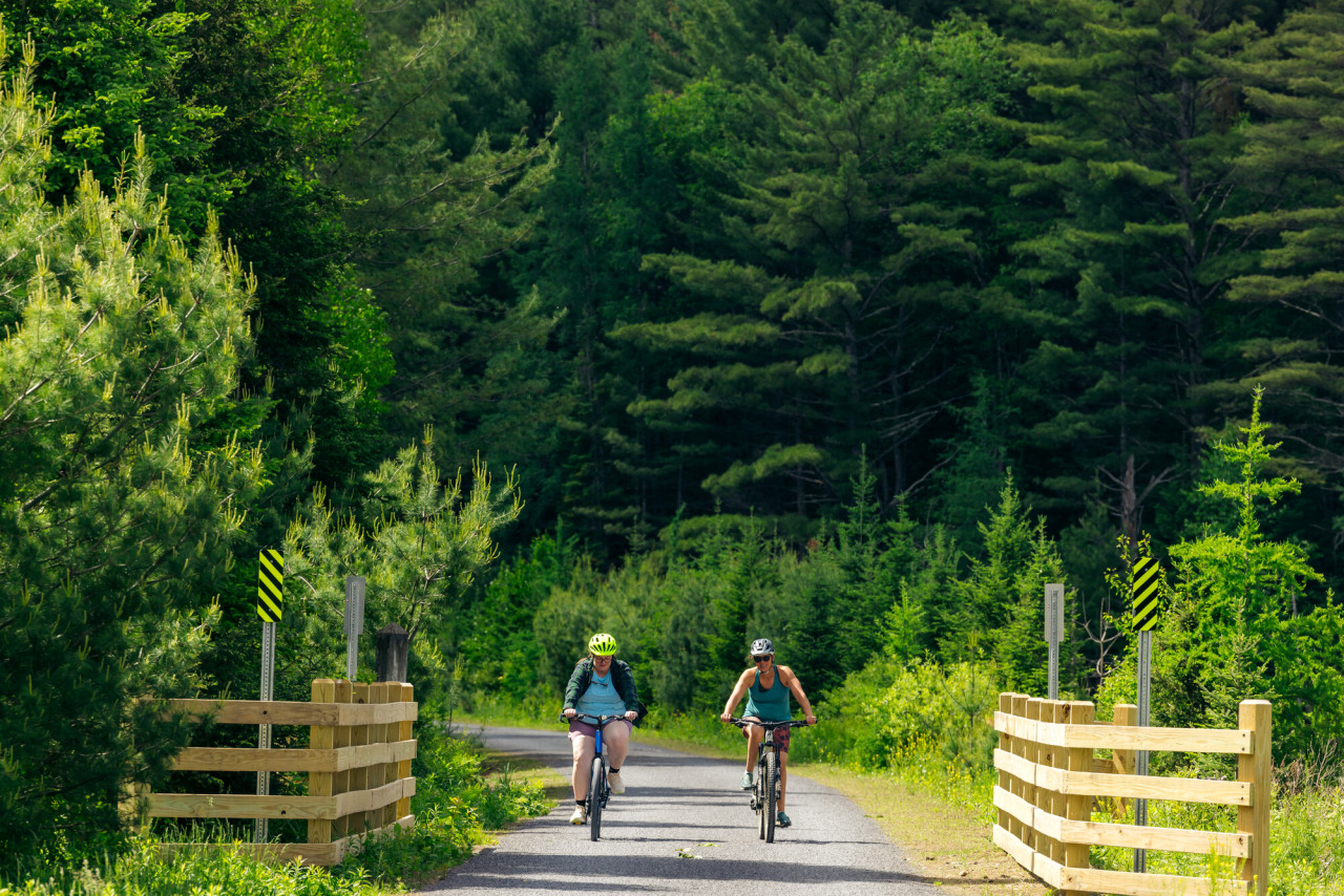 Two women biking on the Adirondack Rail Trail.